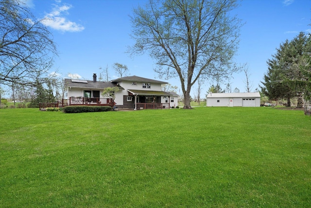 view of yard with a deck and a detached garage