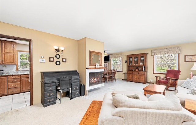 living area featuring a healthy amount of sunlight and light carpet