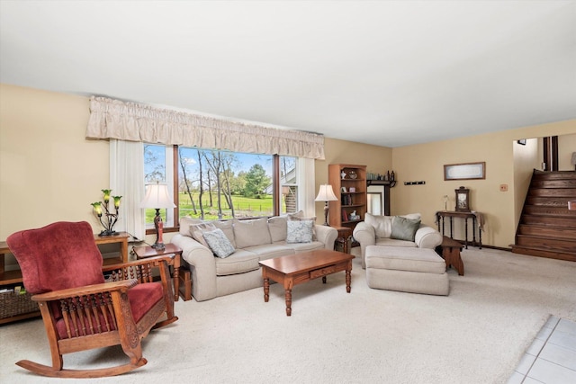 living room featuring carpet floors, stairs, and tile patterned flooring