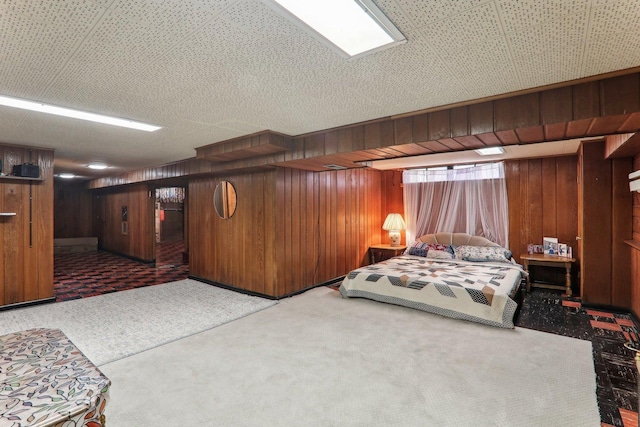 bedroom with wood walls and carpet flooring