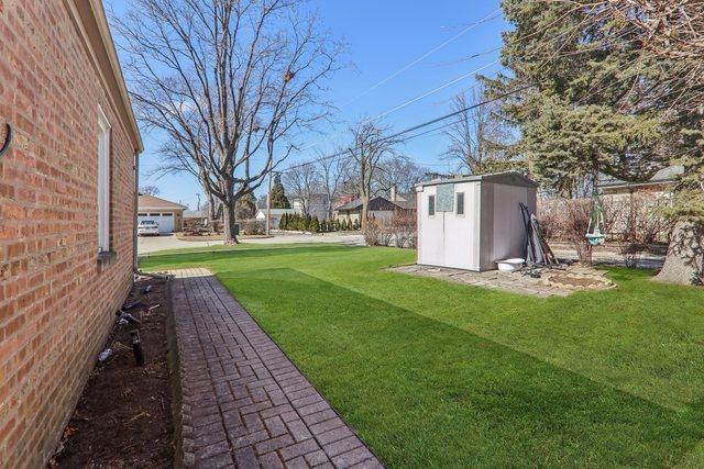 view of yard with an outdoor structure and a shed