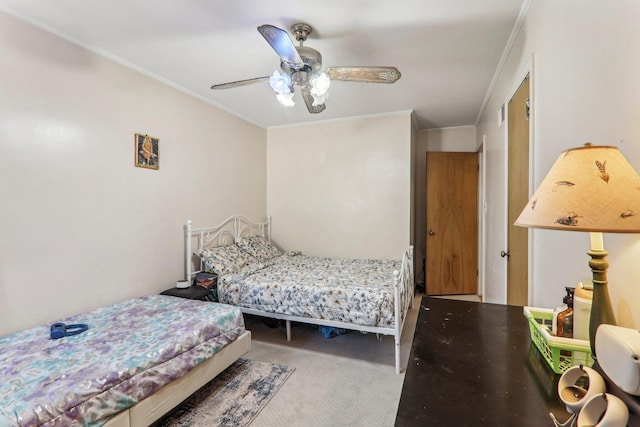 carpeted bedroom featuring a ceiling fan and crown molding