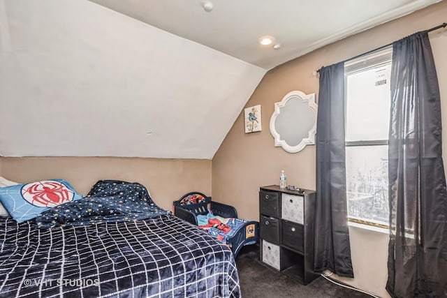 bedroom featuring vaulted ceiling, carpet floors, and multiple windows