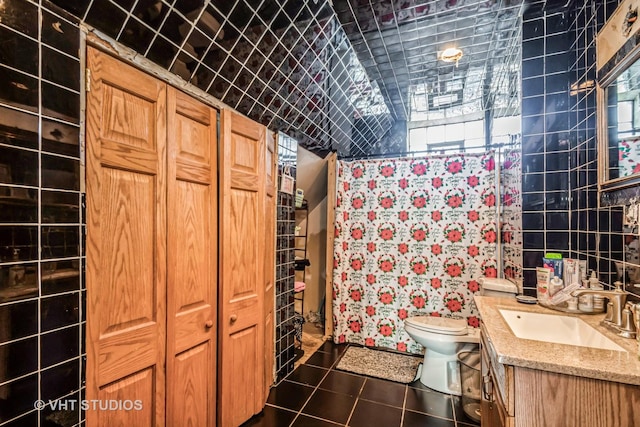 full bathroom featuring a closet, vanity, toilet, and tile patterned floors