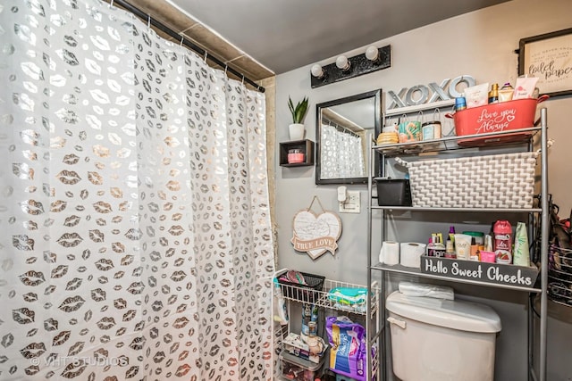 bathroom featuring toilet and a shower with curtain