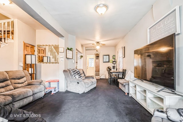 living room featuring a ceiling fan and stairway