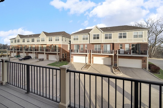 wooden terrace with a garage and a residential view