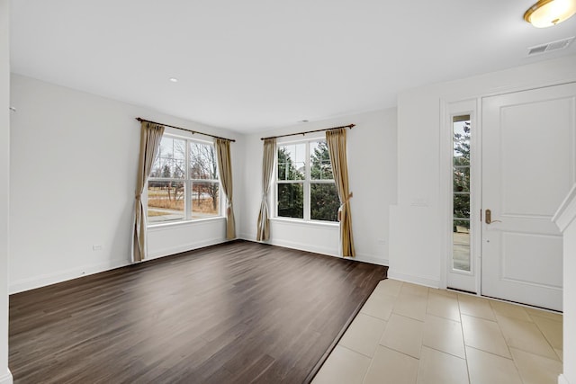 entryway featuring wood finished floors, visible vents, and baseboards