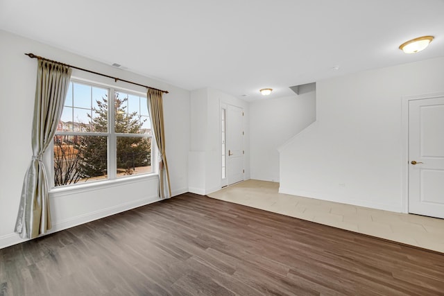 interior space featuring wood finished floors and baseboards