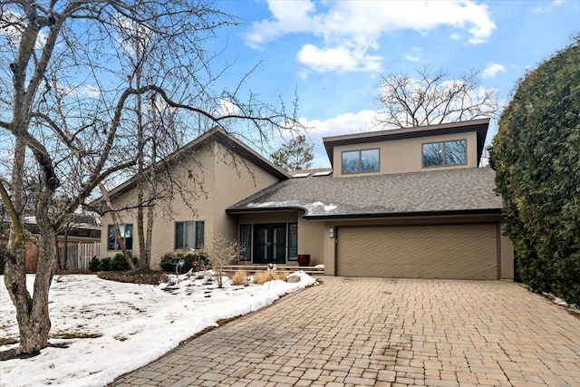 view of front of house with a garage and decorative driveway