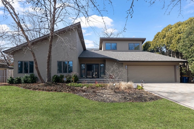 view of front facade with a garage, roof with shingles, concrete driveway, and a front yard