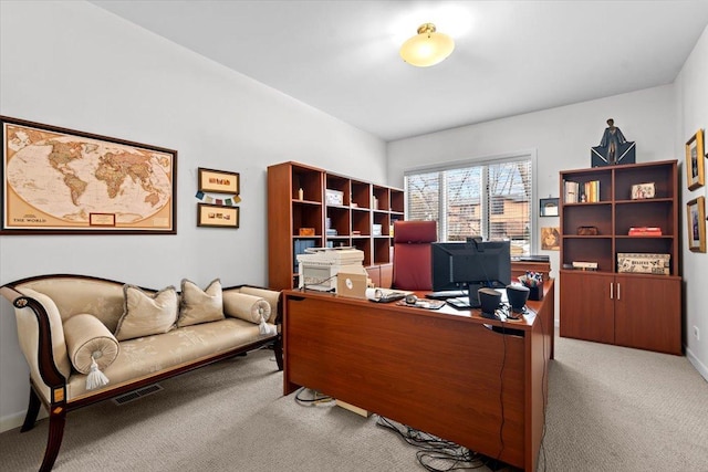 office featuring carpet floors, baseboards, and visible vents