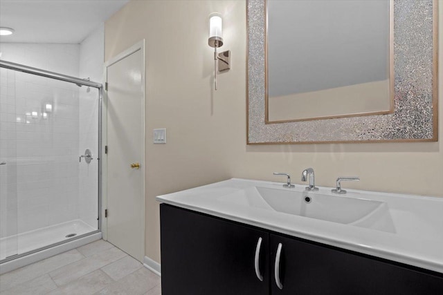 bathroom with a stall shower, tile patterned flooring, and vanity