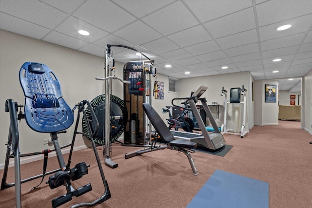 workout room featuring recessed lighting, a paneled ceiling, and baseboards