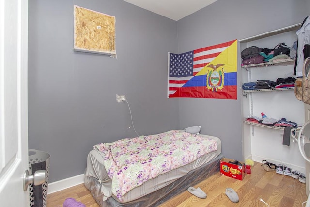 bedroom with wood finished floors and baseboards