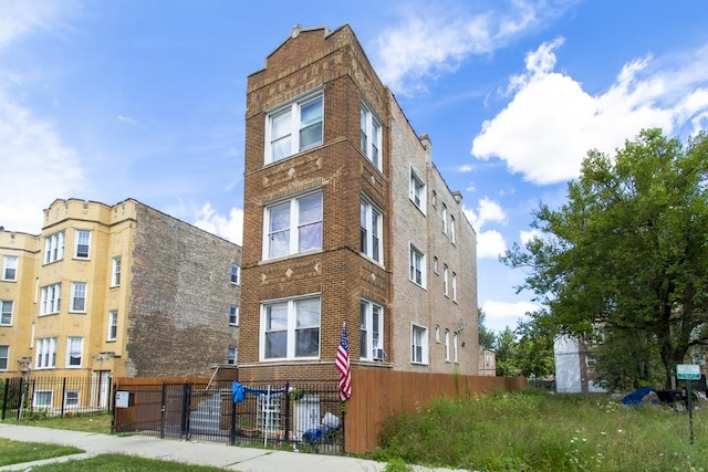 view of building exterior with a fenced front yard