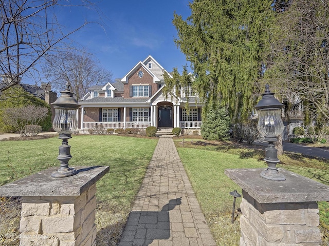 view of front of house with brick siding and a front lawn