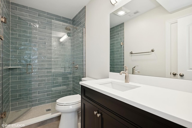 full bath featuring toilet, a shower stall, visible vents, and vanity