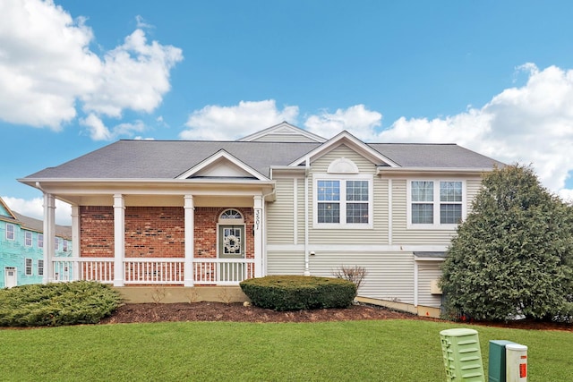 view of front of house featuring brick siding, a porch, and a front yard