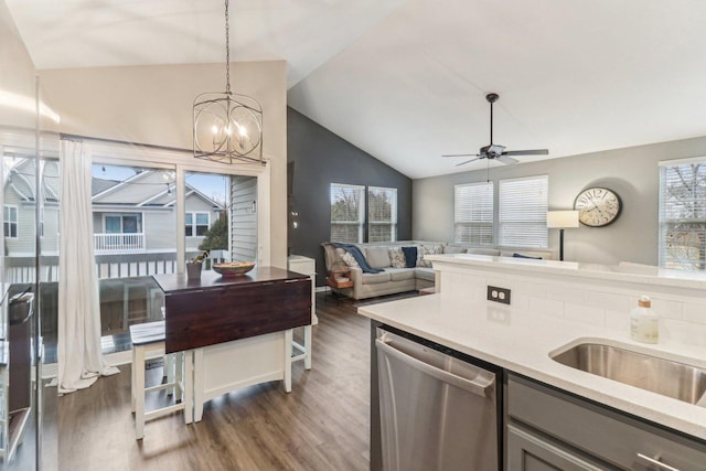 kitchen featuring a healthy amount of sunlight, light countertops, dishwasher, and ceiling fan with notable chandelier