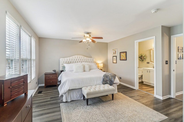 bedroom with a ceiling fan, dark wood-style flooring, baseboards, and ensuite bathroom