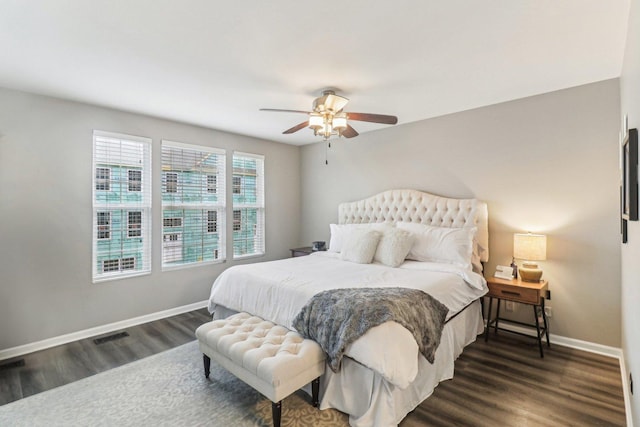 bedroom featuring dark wood-type flooring, a ceiling fan, and baseboards