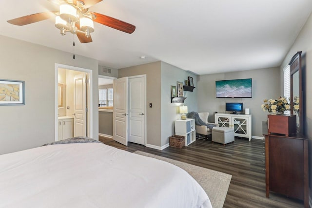 bedroom with dark wood-style floors, multiple windows, and baseboards