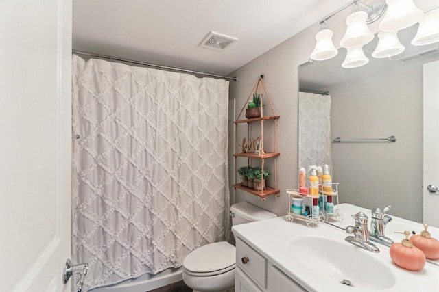 bathroom featuring visible vents, vanity, and toilet