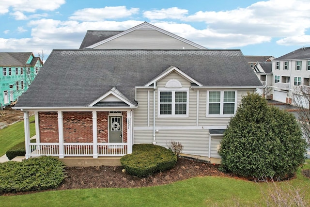 view of front of home featuring a porch and brick siding