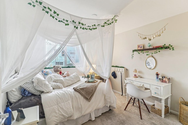 bedroom featuring light colored carpet and baseboards