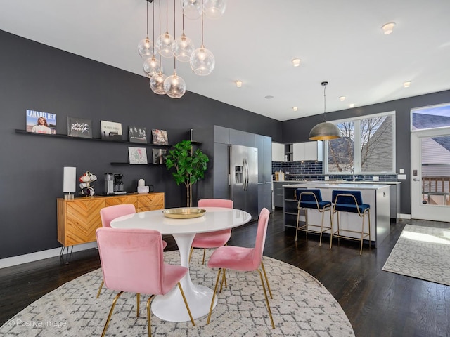 dining area with dark wood-style floors and baseboards