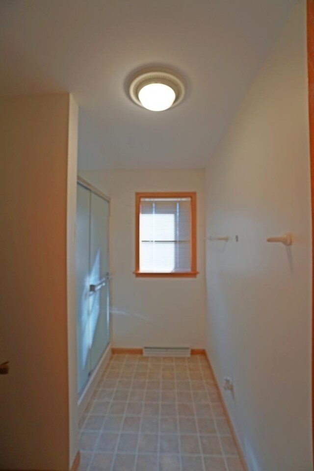 interior space with baseboards and a baseboard heating unit