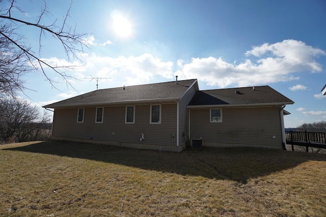 rear view of property featuring a lawn