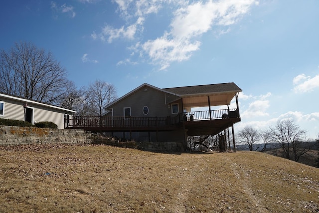 view of side of property featuring a wooden deck