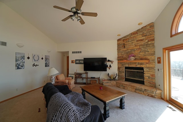 carpeted living area with high vaulted ceiling, a fireplace, and visible vents