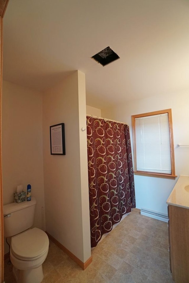 bathroom featuring a shower with shower curtain, baseboard heating, toilet, vanity, and baseboards