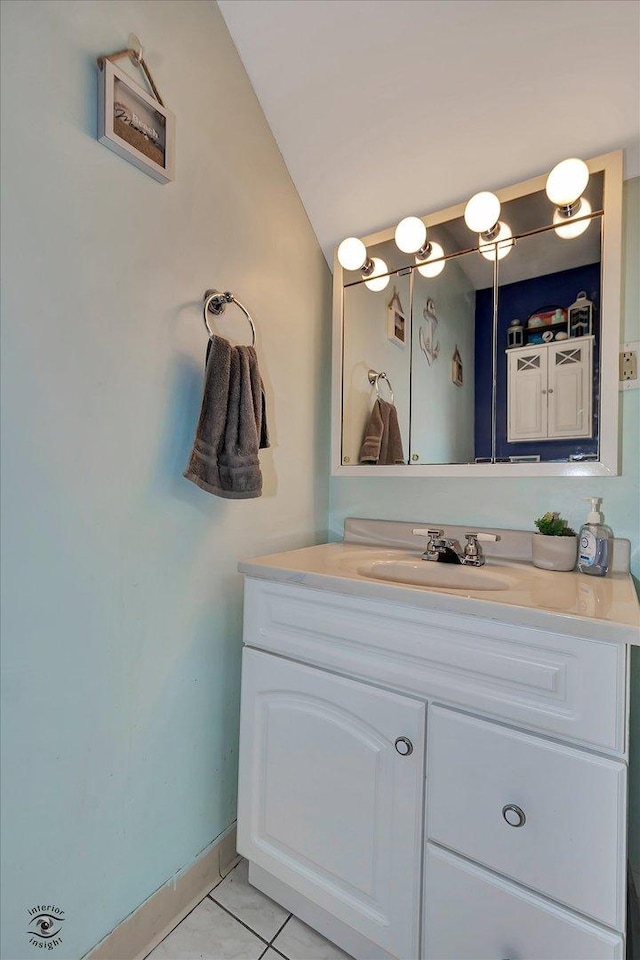 bathroom featuring tile patterned floors, baseboards, and vanity