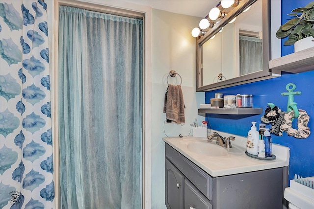 full bathroom featuring vanity and toilet