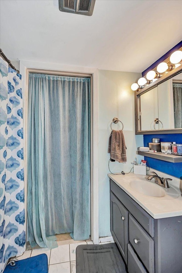 full bath featuring tile patterned floors, visible vents, and vanity