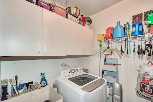 laundry room featuring washer / clothes dryer, cabinet space, and a sink