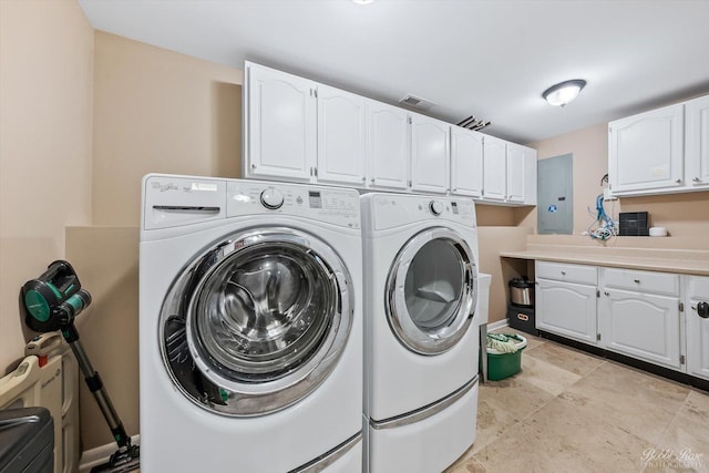 clothes washing area with cabinet space, washing machine and dryer, and electric panel