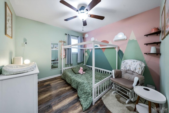 bedroom with wood finished floors, a ceiling fan, and baseboards