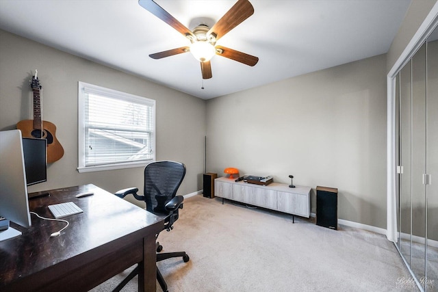 office area featuring carpet flooring, ceiling fan, and baseboards