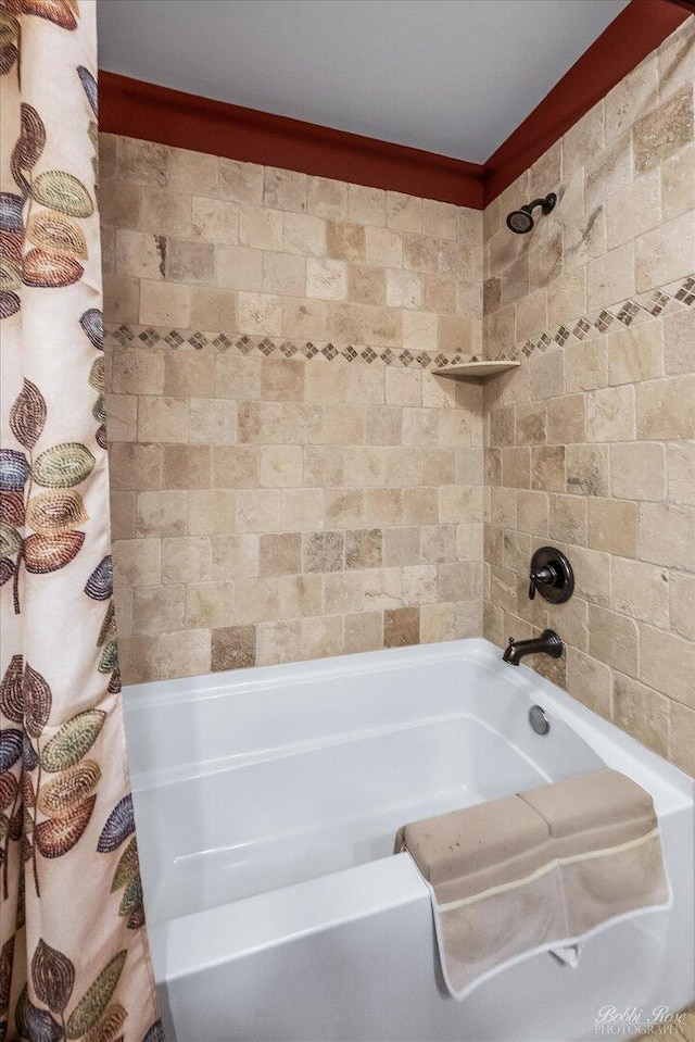 full bathroom with ornamental molding and shower / tub combo