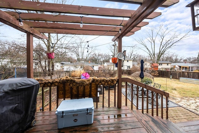 wooden deck with a residential view, a fenced backyard, a grill, and a pergola