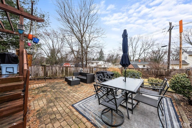 view of patio / terrace featuring a fenced backyard, an outdoor hangout area, and outdoor dining space