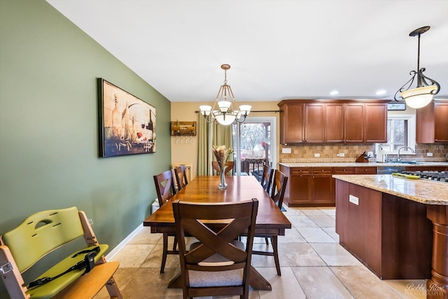 dining room featuring a chandelier, recessed lighting, baseboards, and light tile patterned floors