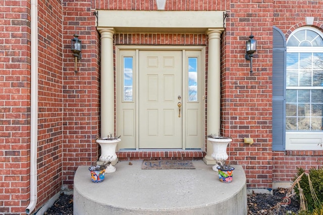 property entrance featuring brick siding