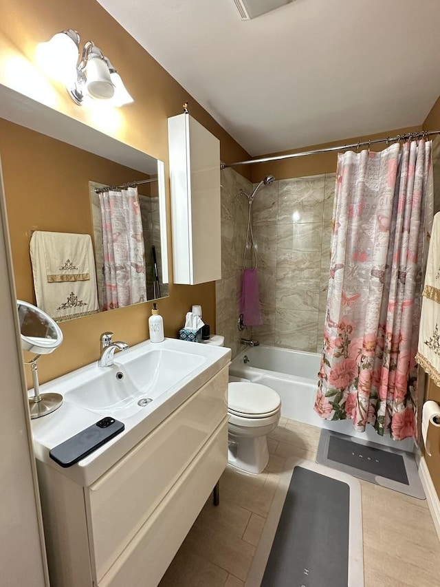 full bath featuring shower / bath combo with shower curtain, vanity, and toilet