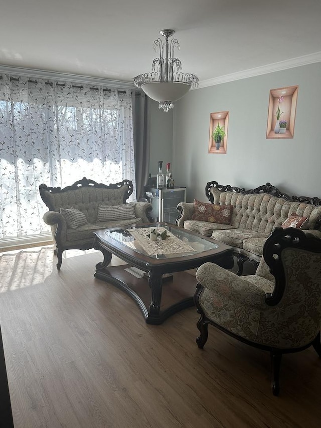 living area featuring a wealth of natural light, crown molding, and wood finished floors